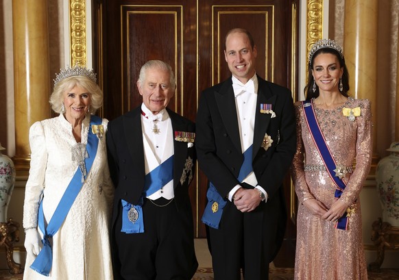 Britain&#039;s Queen Camilla, King Charles III, Prince William and Kate, Princess of Wales pose for a photograph ahead of the Diplomatic Reception in the 1844 Room at Buckingham Palace in London, Engl ...
