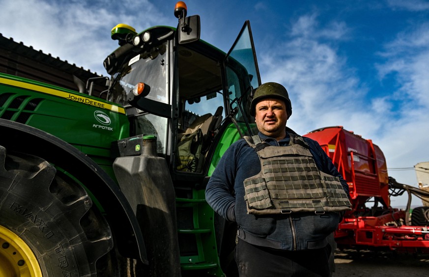 An agrarian wears a bulletproof vest during the sowing which takes place 30 km from the front line, Zaporizhzhia Region, southeastern Ukraine, on April 08, 2022. Photo by Dmytro Smoliyenko/Ukrinform/A ...