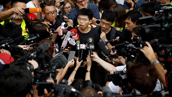 FILE PHOTO: Pro-democracy activist Joshua Wong talks to the media outside the Legislative Council during a demonstration demanding Hong Kong&#039;s leaders to step down and withdraw the extradition bi ...
