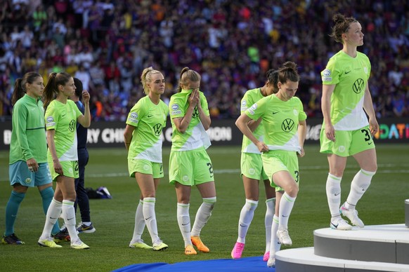 Wolfsburg players walk to collect their second place medals after the Women&#039;s Champions League final soccer match between FC Barcelona and VfL Wolfsburg at the PSV Stadion in Eindhoven, Netherlan ...