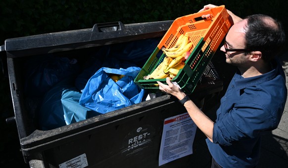 Michael Shaw, Mitarbeiter des Supermarktes Lestra, bringt Obst zu einem Container. Das sogenannte &quot;Containern&quot; ist hier erlaubt. An den Müllcontainern wird sogar mit einem Schild darauf hing ...