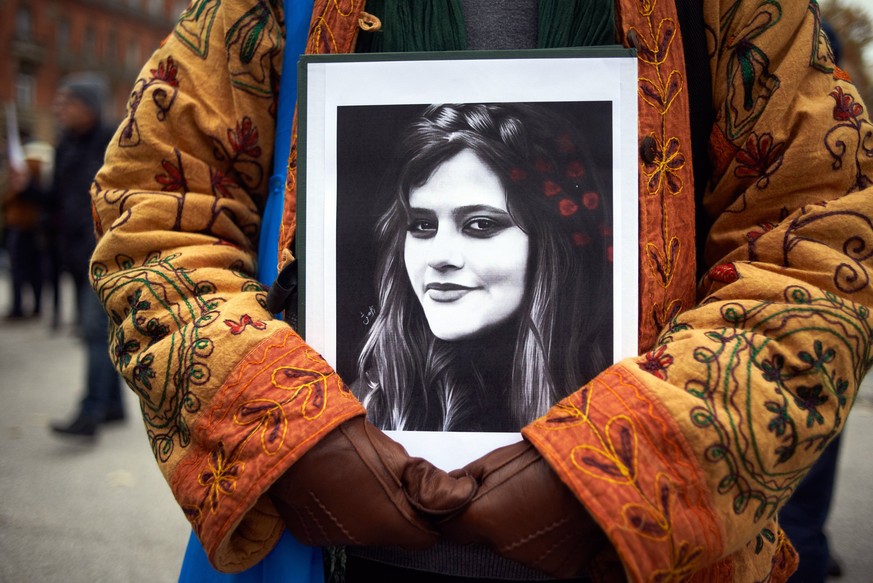 Protest For The Death Of Mahsa Amini And In Support Of Protesters In Iran A protester keeps a drawing of Mahsa Amini. Iranians of Toulouse organized a protest in Toulouse in solidarity with women and  ...