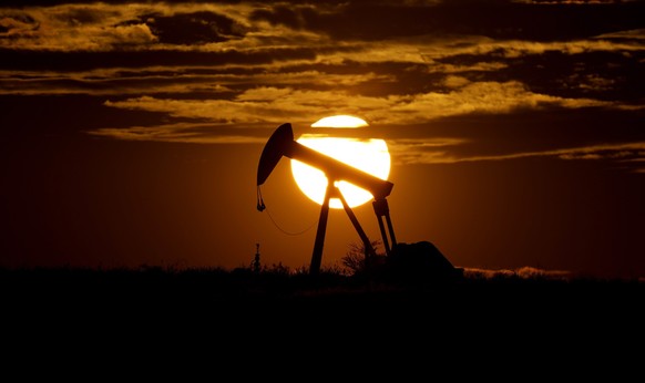 FILE - The sun sets behind an idle pump jack near Karnes City, Texas, April 8, 2020. Texas can feel like a study in contrasts. One example being that the state is famed for its oil industry, but is th ...