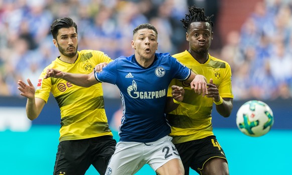 GELSENKIRCHEN, GERMANY - APRIL 15: Amine Harit of FC Schalke 04 is challenged by Nuri Sahin of Borussia Dortmund and Michy Batshuayi of Borussia Dortmund during the Bundesliga match between FC Schalke ...