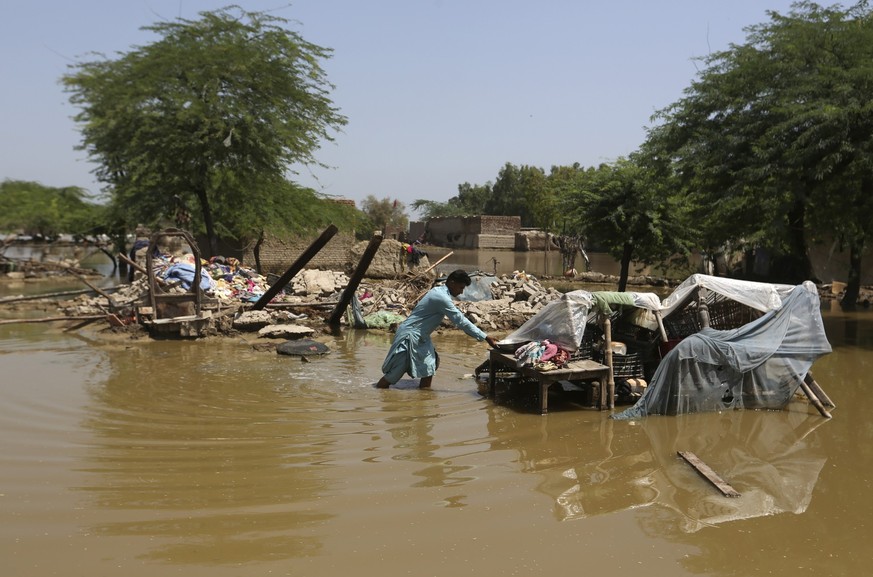 A man looks for salvageable belongings from his flood-damaged home in the Shikarpur district of Sindh Province, Pakistan, Thursday, Sept. 1, 2022. Pakistani health officials on Thursday reported an ou ...