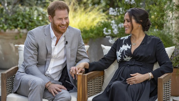 This image provided by Harpo Productions shows Prince Harry, left, and Meghan, Duchess of Sussex, speaking about expecting their second child during an interview with Oprah Winfrey. &quot;Oprah with M ...