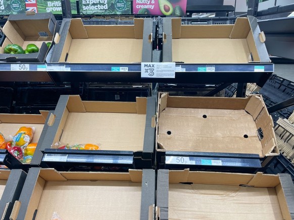 BRISTOL, UNITED KINGDOM - FEBRUARY 19: Empty shelves and boxes are seen alongside fruit and vegetables that are being are offered for sale inside a branch of the supermarket retailer Asda on February  ...