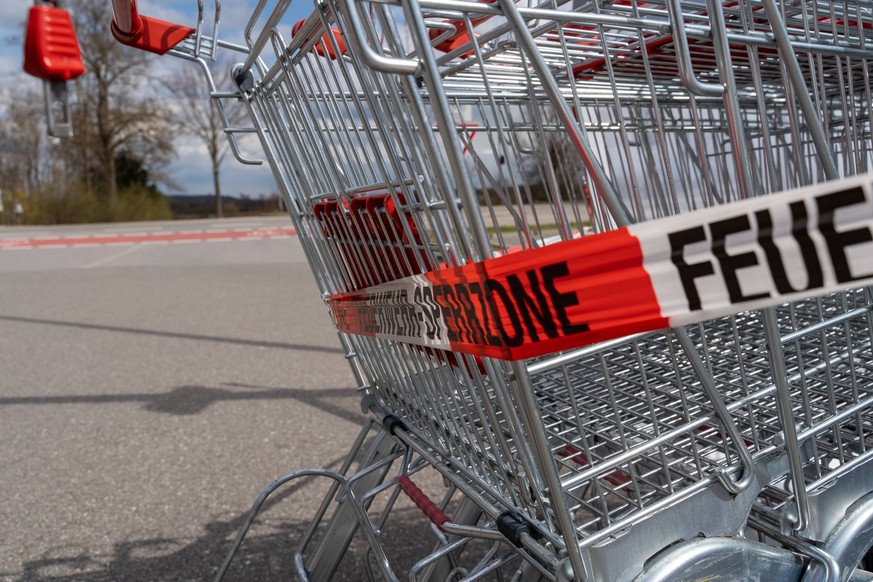 Stettenhofen, Bavaria, Germany - April 10, 2022: Storm Nasin has left damage, a shopping cart box on a supermarket parking lot was torn from the anchorage and blocked off by the fire department *** St ...