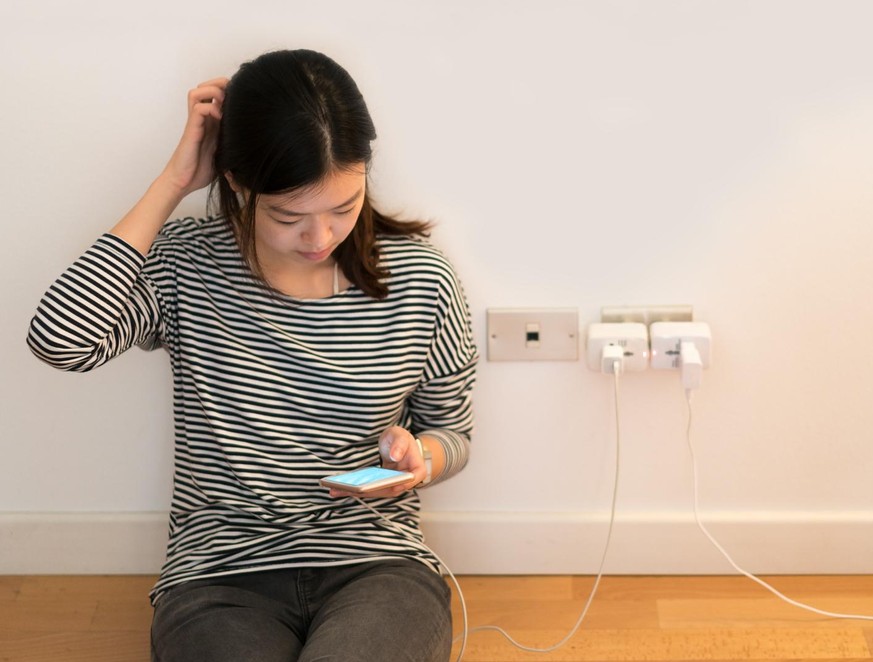 Cute asian girl frustrating with phone, charging battery, with copy space