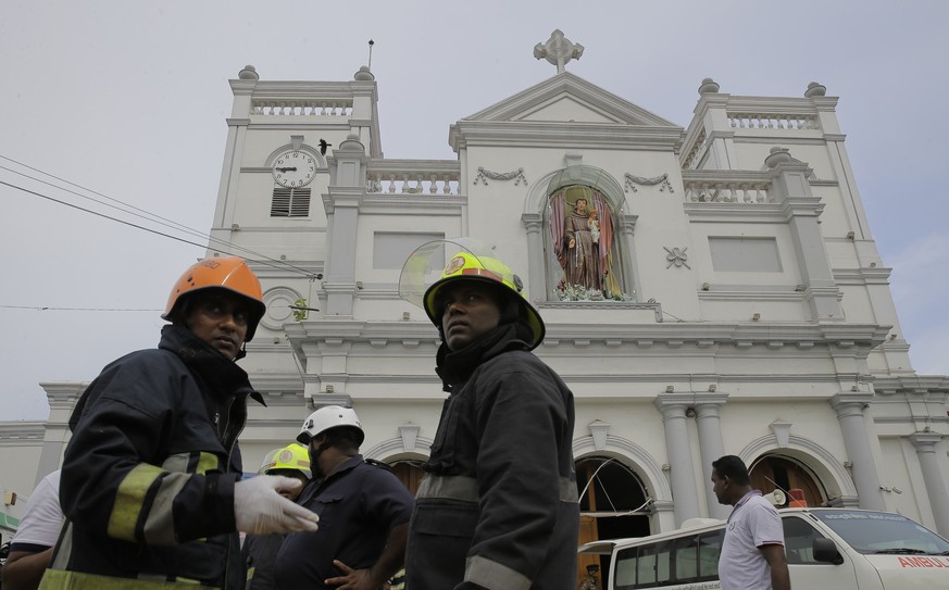 Sri Lankan firefighters stand in the area around St. Anthony&#039;s Shrine after a blast in Colombo, Sri Lanka, Sunday, April 21, 2019. A Sri Lanka hospital spokesman says several blasts on Easter Sun ...