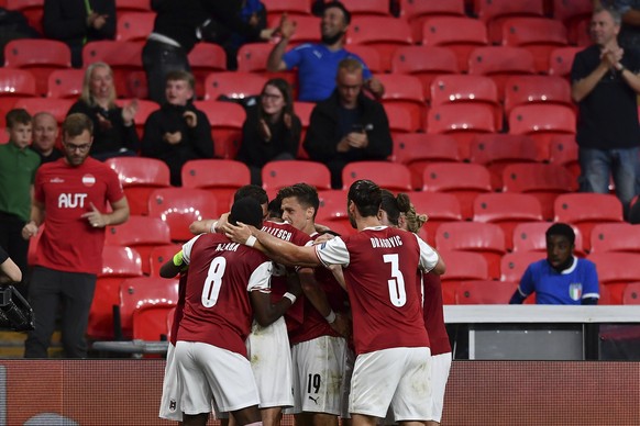 Austria&#039;s Marko Arnautovic celebrates with his teammates after scoring his side&#039;s opening goal that was later disallowed, during the Euro 2020 soccer championship round of 16 match between I ...