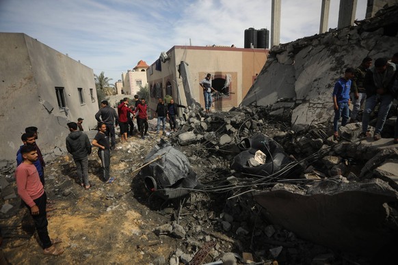 Palestinians search for victims under the rubble after an Israeli strike on residential house. in Rafah in the southern Gaza Strip. on Friday, March 1, 2024.The death toll in Gaza of Palestinians kill ...