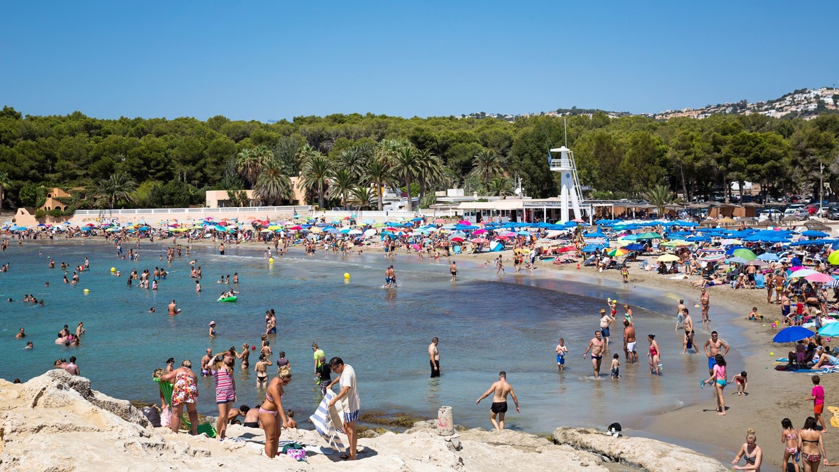 Moraira beach, People on the beach of Moraira Teulada Costa Blanca, Spain