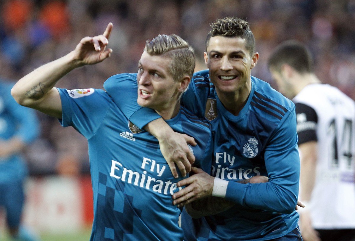FILE - Real Madrid&#039;s Toni Kroos, left, celebrates with Cristiano Ronaldo after scoring, during the Spanish La Liga soccer match between Valencia and Real Madrid at the Mestalla stadium in Valenci ...
