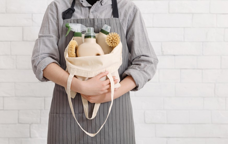 Unrecognizable woman holding Eco friendly products for home cleaning. Natural domestic cleaning, zero waste detergent