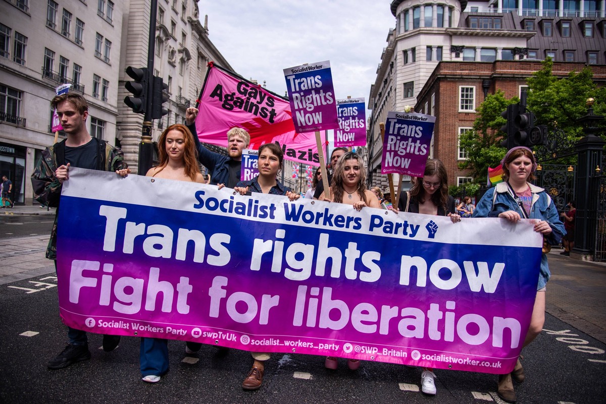 July 8, 2023, London, United Kingdom: Protestors march with a large banner during the London Trans Pride Protest. The march comes against a backdrop of growing anti-trans hostility. London United King ...