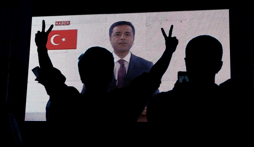 Supporters of Turkey&#039;s main pro-Kurdish Peoples&#039; Democratic Party (HDP) watch the jailed former leader and presidential candidate Selahattin Demirtas as his first television appearance in ov ...