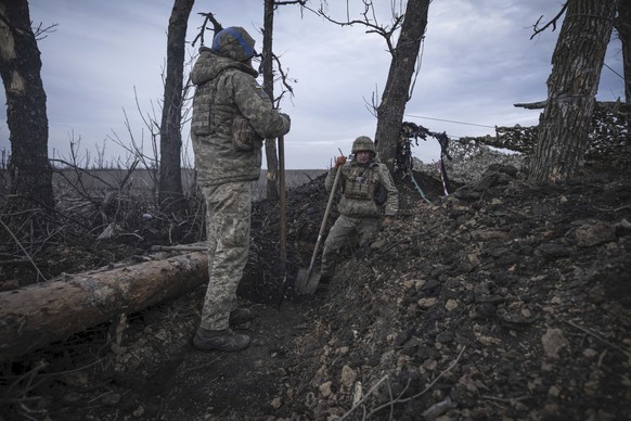 Ukrainian soldiers dig a trench on the front-line near Klishchiivka, Donetsk region, Ukraine, Monday, March 18, 2024. (Iryna Rybakova via AP)