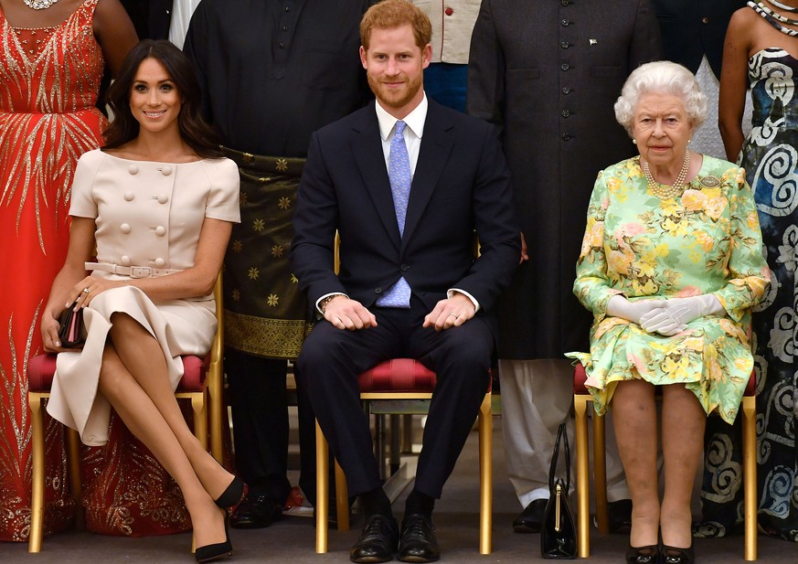 FILE PHOTO: Britain's Queen Elizabeth, Prince Harry and Meghan, the Duchess of Sussex, pose for a picture at in London, Britain June 26, 2018. John Stillwell/Pool via Reuters/File Photo