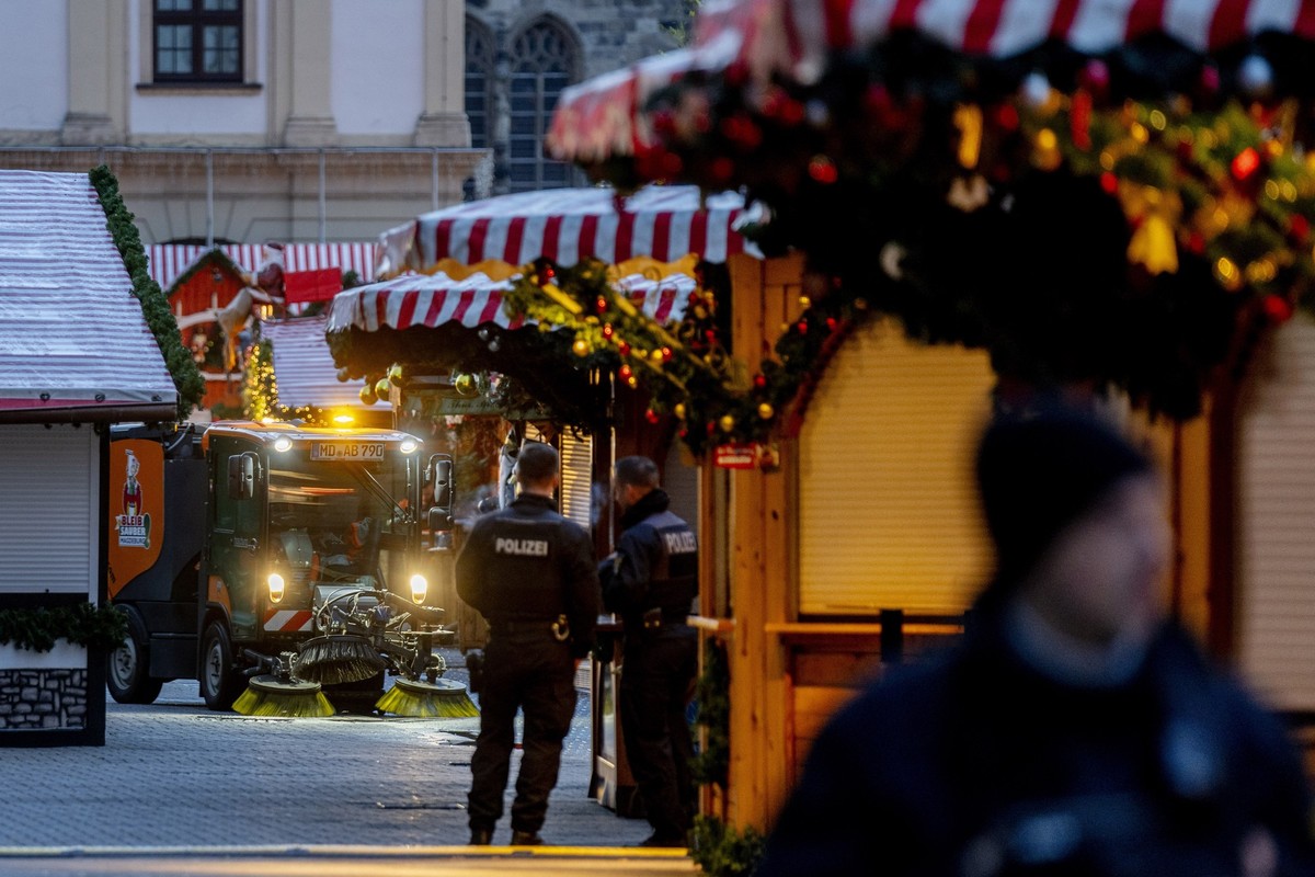 Public workers clean the Christmas Market, where a car drove into a crowd on Friday evening, in Magdeburg, Germany, is empty on Sunday morning , Dec. 22, 2024. (AP Photo/Michael Probst)