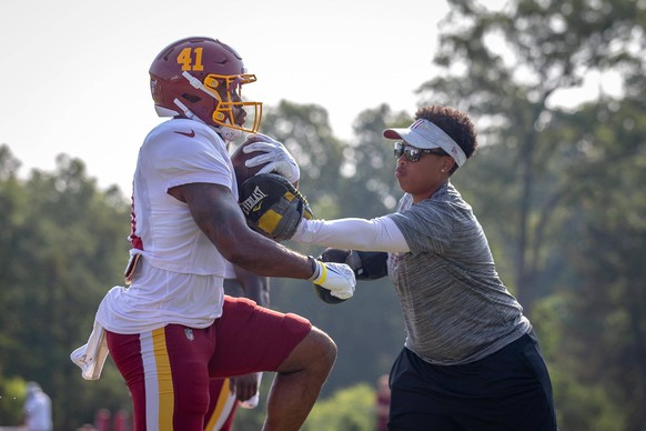 Jennifer King (right) is in charge of running backs on the Washington Football Team. 
