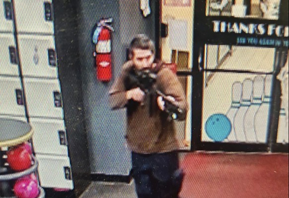 In this image taken from video released by the Androscoggin County Sheriff&#039;s Office, an unidentified shooter points a gun while entering Sparetime Recreation in Lewiston, Maine, on Wednesday, Oct ...