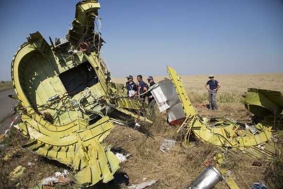 FILE - Australian and Dutch investigators examine pieces of the Malaysia Airlines Flight 17 plane crash in the village of Hrabove, Russian-controlled Donetsk region of eastern Ukraine Friday, Aug. 1,  ...