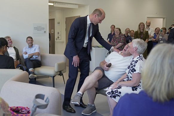 Britain&#039;s Prince William, center, chats with the outpatients as he attends the official opening of the Oak Cancer Centre at The Royal Marsden Hospital in London, Thursday, June 8, 2023. (AP Photo ...