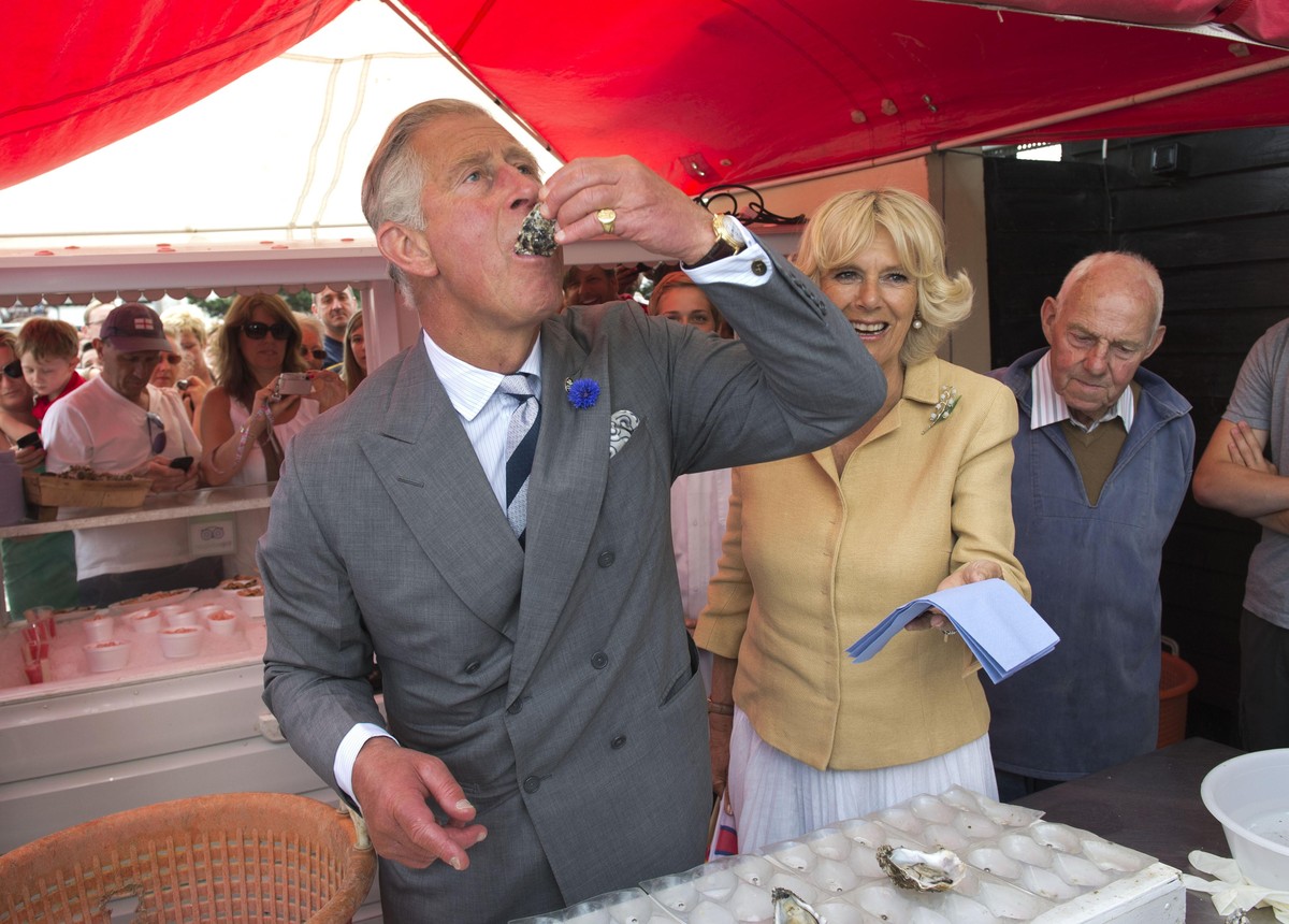 Royal visit to kent. The Prince of Wales tries an oyster with the Duchess of Cornwall at the Whitstable Oyster Festival in Kent. Picture date: Monday July 29, 2013. The Prince of Wales and the Duchess ...