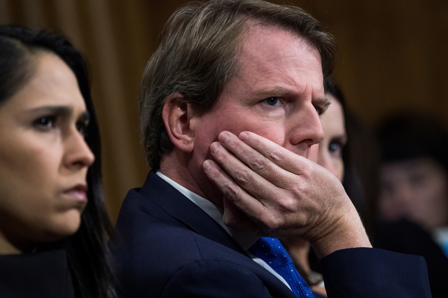 FILE PHOTO: White House counsel Don McGahn listens to Christine Blasey Ford testify during the Senate Judiciary Committee hearing on the nomination of Brett M. Kavanaugh to be an associate justice of  ...