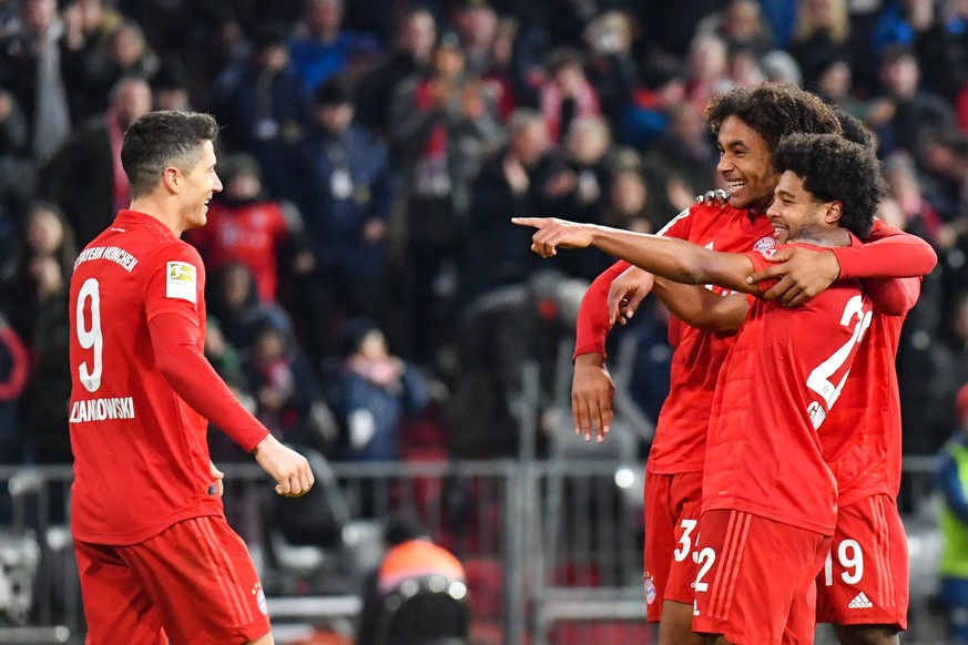 SOCCER - 1.DFL, Bayern vs Wolfsburg MUNICH,GERMANY,21.DEC.19 - SOCCER - 1. DFL, 1. Deutsche Bundesliga, FC Bayern Muenchen vs VfL Wolfsburg. Image shows Robert Lewandowski and Serge Gnabry and Joshua  ...