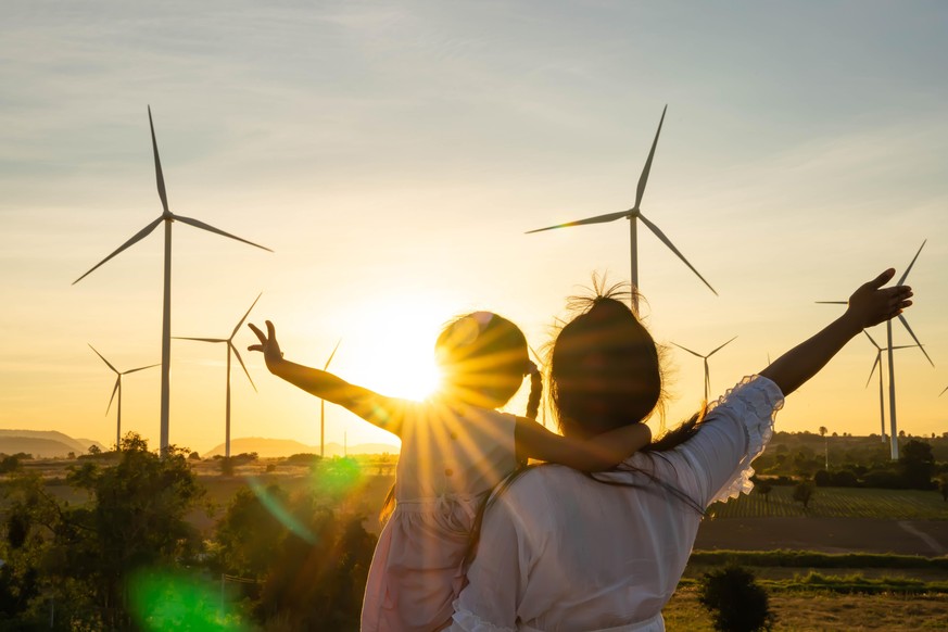 Wind turbines are alternative electricity sources, the concept of sustainable resources, People in the community with wind generators turbines, Renewable energy.