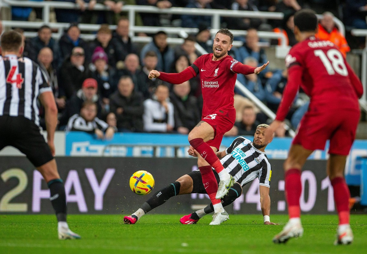 18th February 2023 St James Park, Newcastle, England: Premier League Football, Newcastle United versus Liverpool Joelinton Apolinario De Lira of Newcastle United slide tackles Jordan Henderson of Live ...