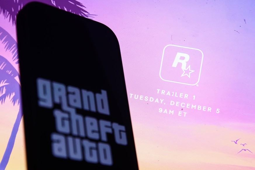 Rockstar Grand Theft Auto Announcement Photo Illustrations Rockstar website announcing GTA 6 trailer displayed on a laptop screen and Grand Theft Auto logo displayed on a phone screen are seen in this ...