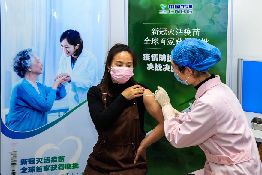 201231 -- BEIJING, Dec. 31, 2020 -- A volunteer receives the COVID-19 vaccine developed by Wuhan Biological Products Institute Co., Ltd. in Wuzhi County, central China s Henan Province, April 12, 2020 ...
