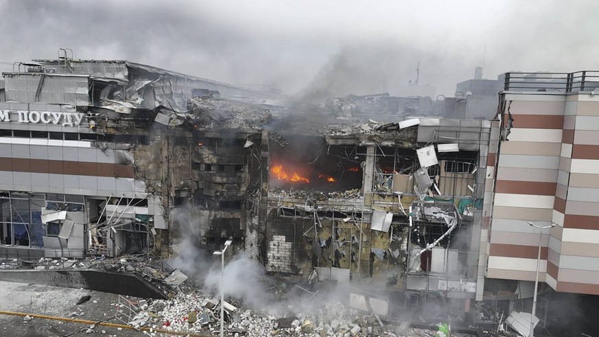 In this photo provided by the Ukrainian Emergency Service, firefighters work in ruins of a mall damaged in Russia&#039;s most massive missile attack in Dnipro, Ukraine, Friday, Dec. 29, 2023. (Ukraini ...