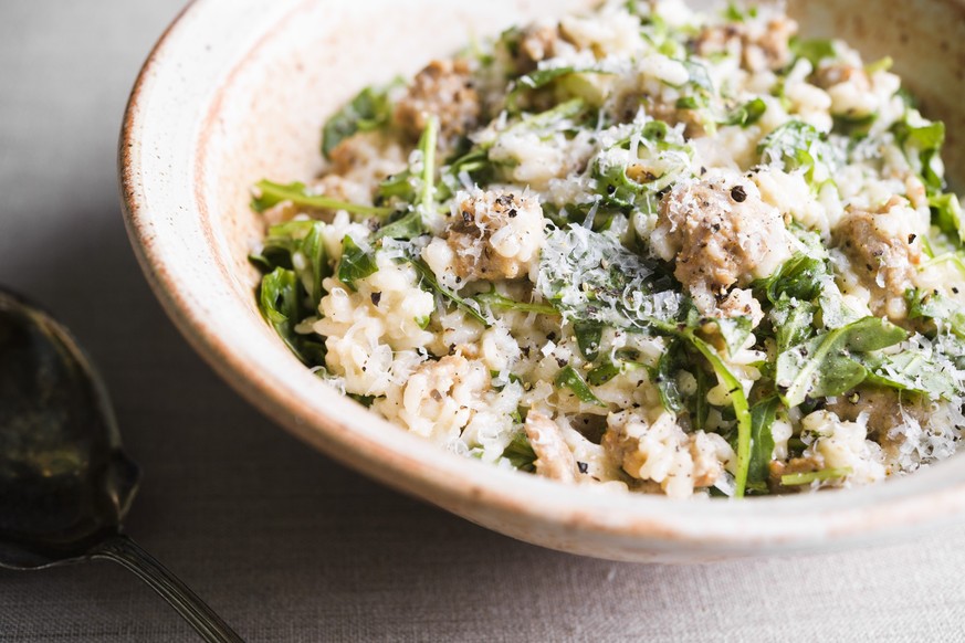 This image released by Milk Street shows a recipe for risotto with sausage. (Milk Street via AP)