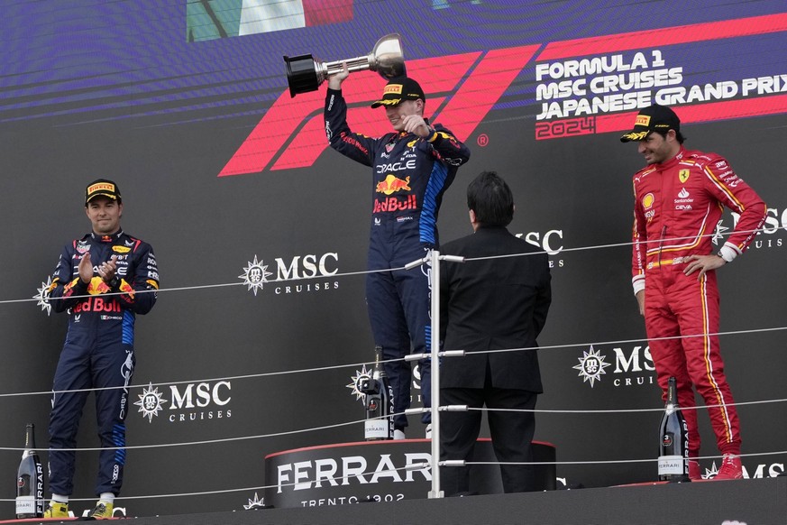 07.04.2024, Japan, Suzuka: Motorsport: Formel-1-Weltmeisterschaft, Grand Prix von Japan, Rennen, der niederländische Red-Bull-Pilot Max Verstappen (M) feiert auf dem Podium seinen Sieg beim Großen Pre ...