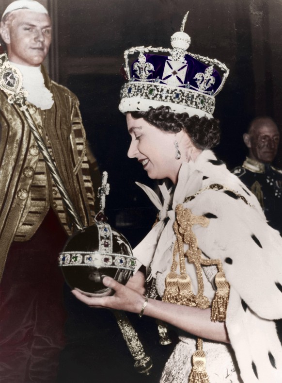 Queen Elizabeth II returning to Buckingham Palace after her Coronation at Westminster Abbey, London, June 1953. (Colorised black and white print).