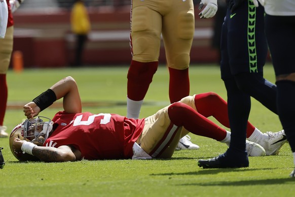 San Francisco 49ers quarterback Trey Lance (5) lies on the field after being tackled during the first half of an NFL football game against the Seattle Seahawks in Santa Clara, Calif., Sunday, Sept. 18 ...