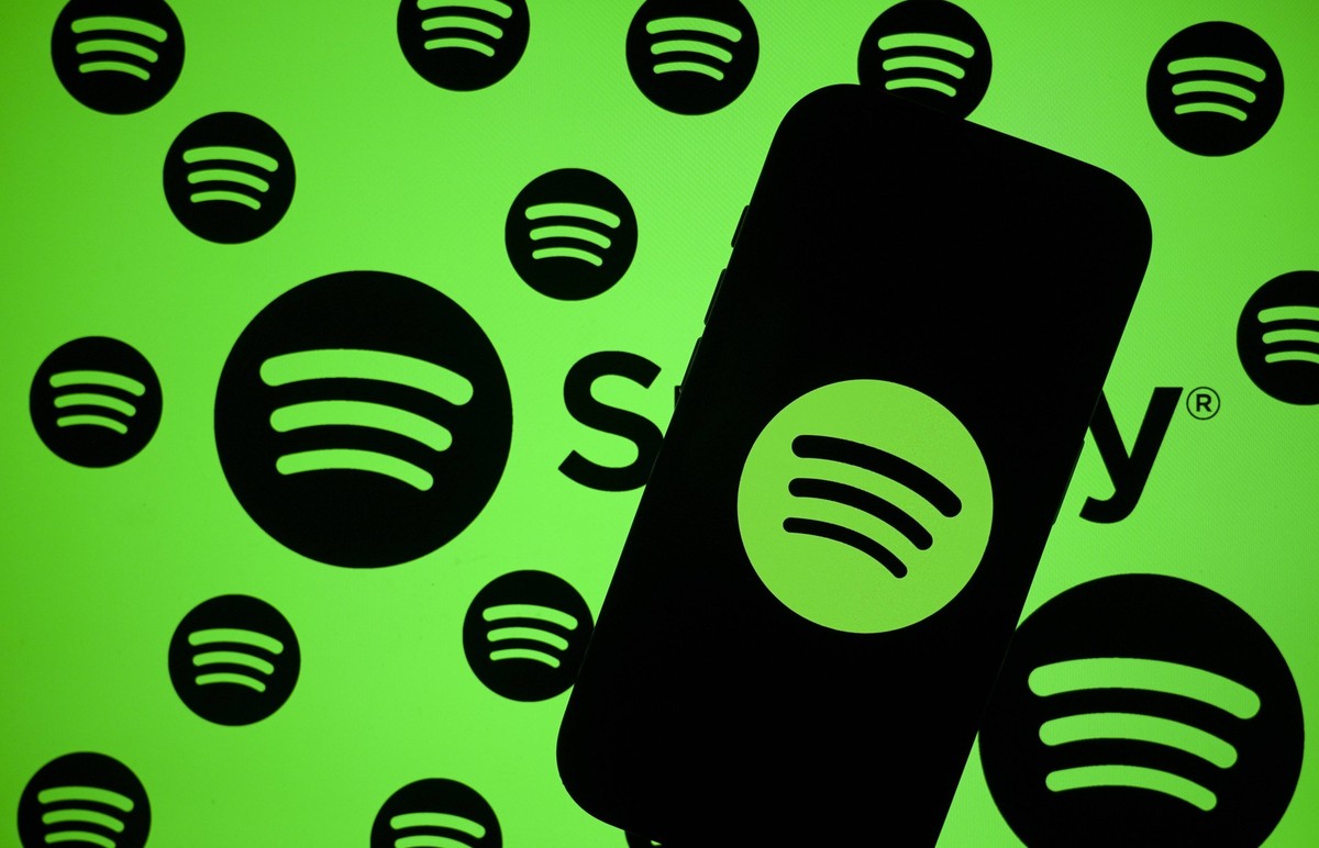 Spotify ANKARA, TURKIYE - OCTOBER 24: In this photo illustration the logo of Spotify is being displayed on a mobile phone screen in front of computer screen displaying the logos of Spotify in Ankara,  ...