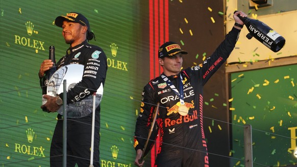 Red Bull driver Max Verstappen of Netherlands, right, and Mercedes driver Lewis Hamilton of Britain celebrate on the podium after the Australian Formula One Grand Prix at Albert Park in Melbourne, Sun ...