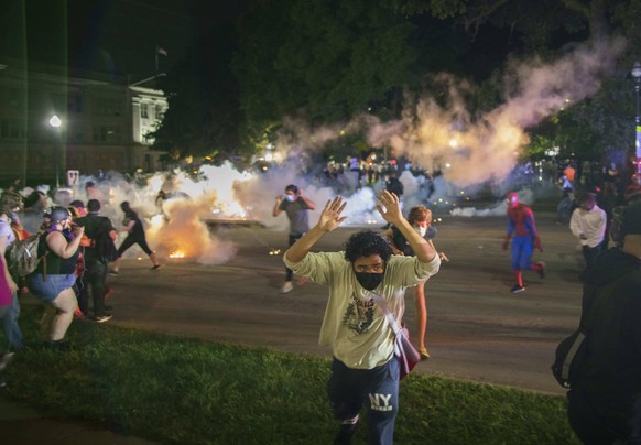 August 25, 2020, Kenosha, Wisconsin: Tear gas lands near protesters after they refused to listen to the demands of police to disperse near the courthouse in Kenosha. Businesses were destroyed, and two ...