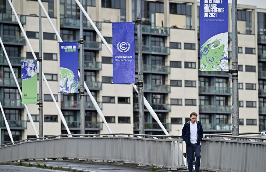 GLASGOW, SCOTLAND - OCTOBER 13: Members of the public cross the Clyde Arc road bridge by the Scottish Events Centre (SEC) which will be hosting the COP26 UN Climate Summit on October 13, 2021 in Glasg ...