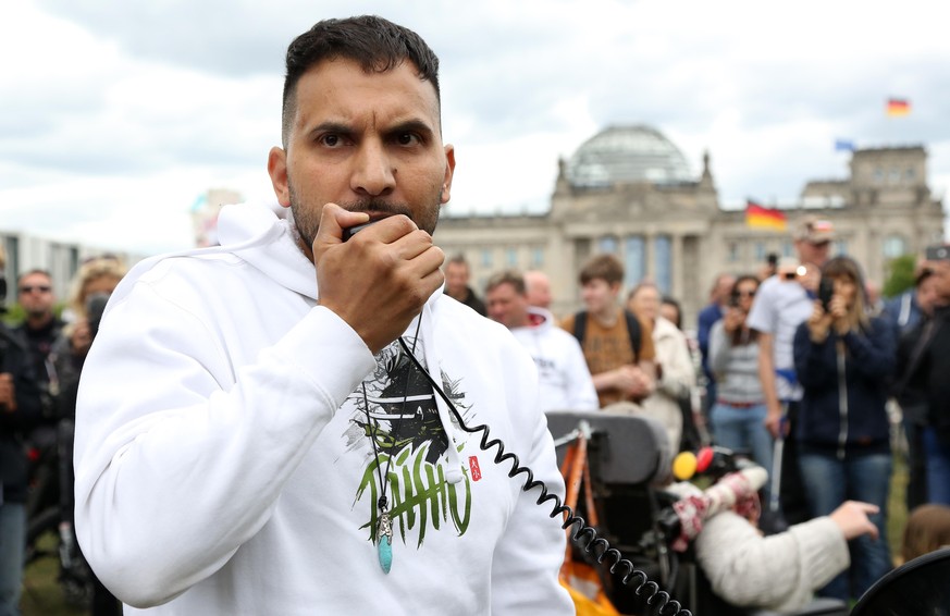 BERLIN, GERMANY - MAY 30: German vegan cookbook author and activist Attila Hildmann speaks as demonstrators attend a protest rally against coronavirus restrictions next to the German federal Chancelle ...