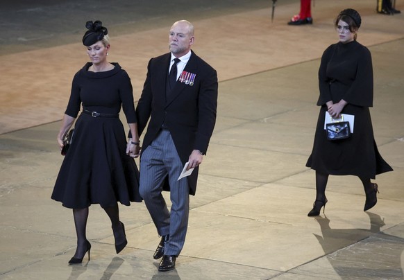 Zara Tindall, her husband Mike Tindall and Princess Eugenie walk as the procession with the coffin of Britain's Queen Elizabeth arrives at Westminster Hall in London, Wednesday, Sept. 14, 2022. The Qu ...