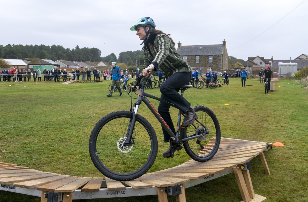 Britain's Kate, Princess of Wales, known as the Duchess of Rothesay when in Scotland, rides a bike during a visit to Outfit Moray, an award-winning charity delivering life-changing outdoor learni ...