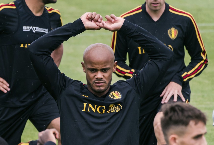 FILE - In this June 1, 2018 fiel photo Belgium&#039;s Vincent Kompany warms up with other Belgian players during a training session at the Belgian Football Center in Tubize, Belgium. (AP Photo/Geert V ...