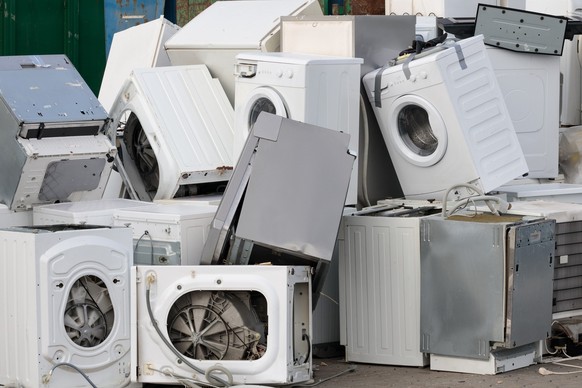 A pile of used household appliances, close-up. Environmental problem, electronics recycling