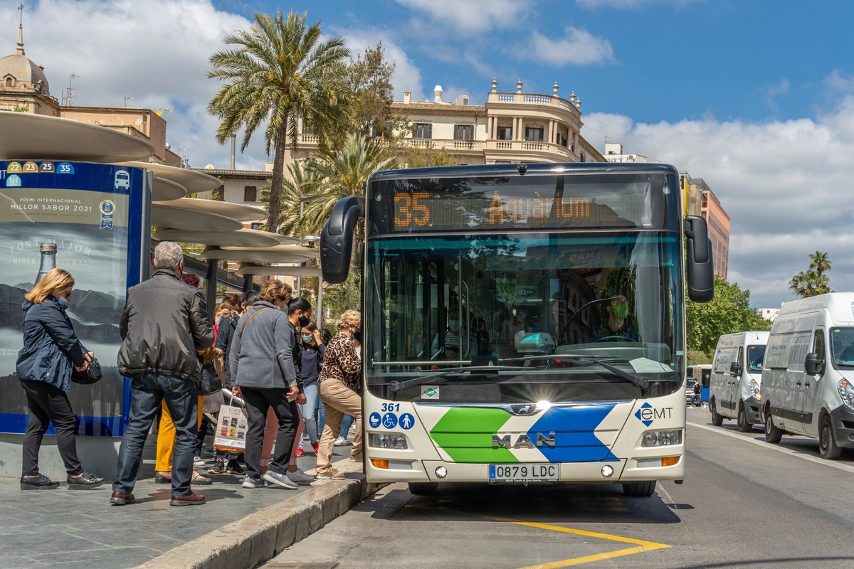 Palma de Mallorca, Spain; april 23 2021: Bus stop at Plaza Espana in Palma de Mallorca. Passengers and driver wearing facial surgical masks due to the Coronavirus Pandemic. New normality concept